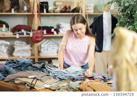 Teen chooses jeans 130394729