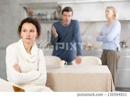 Man scolds woman and old woman stands nearby and looks at it 130394811