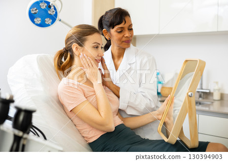 Positive young woman evaluating quality of cosmetological procedures 130394903
