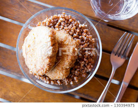 Traditional Ukrainian dish - lunch bowl with buckwheat porridge and cutlet. Healthy dinner 130394975