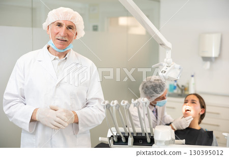 Senior man doctor is standing in dental office, clinic 130395012