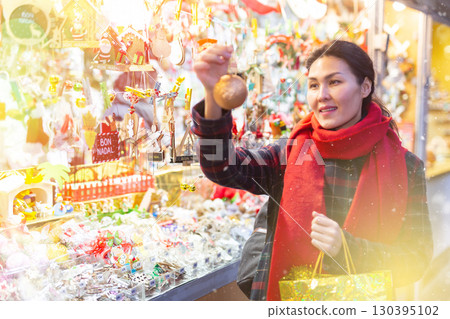 Woman purchasing christmas decorations 130395102