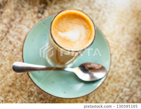 Freshly prepared cortado coffee in glass Freshly prepared cortado coffee in glass 130395105