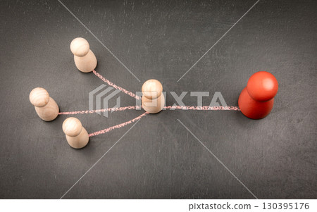 Leader figure connected to team members with chalk lines symbolizing communication and authority 130395176