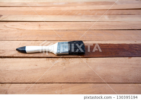 Paint brush and wood material in construction work. 130395194