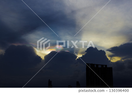 Cloud iridescence or irisation over the dark sky. occurs when sunlight reflects off water droplets in the atmosphere. Cloud iridescence or irisation over the dark sky. occurs when sunlight reflects off water droplets in the atmosphere. 130396400