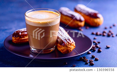 Clear glass layered coffee with artisan eclairs served on a sleek modern plate Clear glass layered coffee with artisan eclairs served on a sleek modern plate 130396558