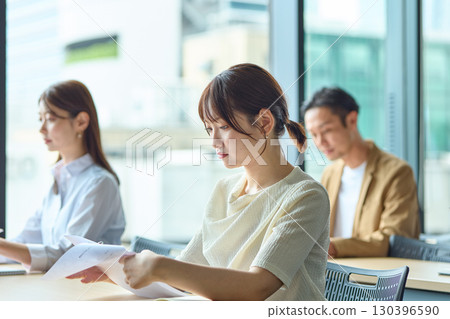 Women taking a written exam Women taking a written exam 130396590