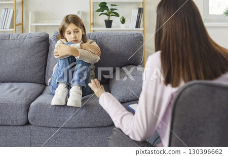 Sad worried child with stress and behavior problem at therapy session in office of psychologist Sad worried child with stress and behavior problem at therapy session in office of psychologist 130396662