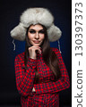beautiful girl in shirt and fur hat 130397373