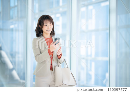 A woman using a smartphone 130397777
