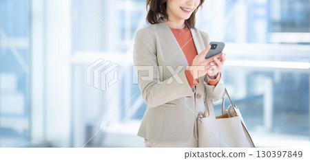 A woman using a smartphone 130397849