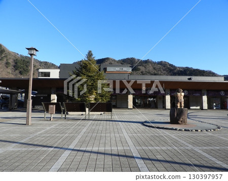 Kinugawa Onsen Station and the station square shining against the blue sky 130397957