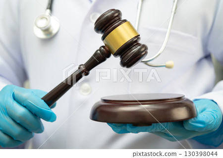 Doctor holding judge gavel, forensic medicine, medical law and crime justice. 130398044