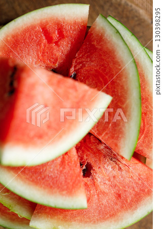 Slices of fresh watermelon on rustic wooden background. Slices of fresh watermelon on rustic wooden background. 130398295