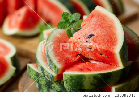 Slices of fresh watermelon on rustic wooden background. Slices of fresh watermelon on rustic wooden background. 130398313