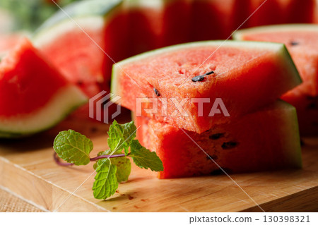 Slices of fresh watermelon on rustic wooden background. Slices of fresh watermelon on rustic wooden background. 130398321