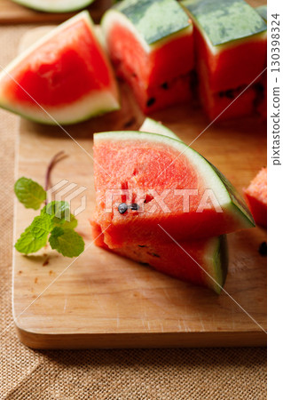 Slices of fresh watermelon on rustic wooden background. 130398324