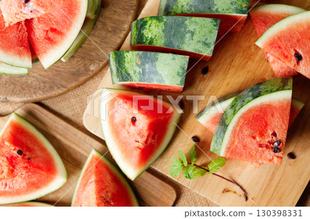 Slices of fresh watermelon on rustic wooden background. 130398331