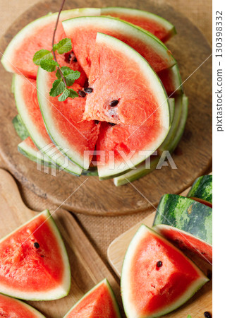Slices of fresh watermelon on rustic wooden background. 130398332