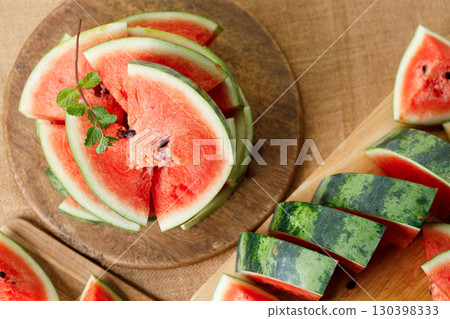 Slices of fresh watermelon on rustic wooden background. 130398333