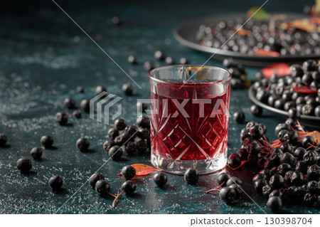 Black chokeberry drink and fresh berries. Black chokeberry drink and fresh berries. 130398704