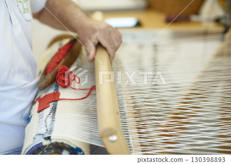 Handloom Weaving Process with Shuttle, Yarn, and Beater Handloom Weaving Process with Shuttle, Yarn, and Beater 130398893
