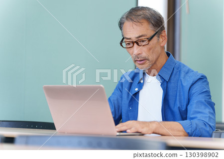 Senior man having trouble using a computer 130398902