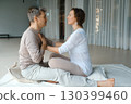 Couples engaging in mindfulness practice during a wellness retreat in a serene studio setting focused on emotional connection and relaxation techniques 130399460