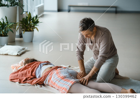 Relaxation therapy session taking place in a serene indoor studio with plants, focusing on wellness and rejuvenation in a tranquil environment 130399462