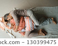 Couples embrace in warm colors, sharing comfort and intimacy in a cozy indoor setting during a relaxing afternoon 130399475