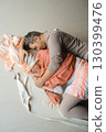 Couples embrace in warm colors, sharing comfort and intimacy in a cozy indoor setting during a relaxing afternoon 130399476