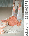 Wellness session in a serene studio focuses on relaxation techniques using a supportive wrap during a tranquil midday practice 130399478