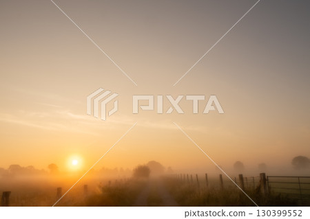 The Serene Sunrise in a Misty Landscape Captures the Calm and Beauty of Natures Awakening The Serene Sunrise in a Misty Landscape Captures the Calm and Beauty of Natures Awakening 130399552