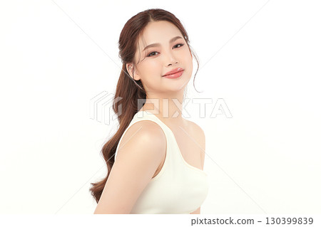 A beautiful young Asian woman with clean, fresh skin against a white background. Skincare, facial treatment, cosmetology, beauty, and spa. An elegant portrait of an Asian woman. A beautiful young Asian woman with clean, fresh skin against a white background. Skincare, facial treatment, cosmetology, beauty, and spa. An elegant portrait of an Asian woman. 130399839