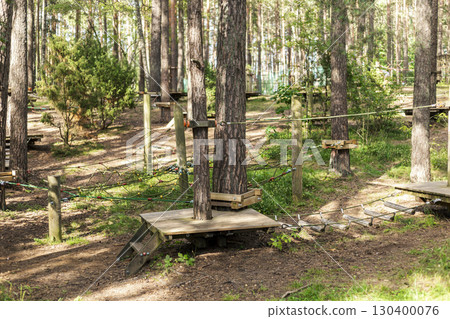 Tree climbing park offers various routes for exploration among towering trees. The area is designed with platforms and ropes for an adventurous experience in a tranquil forest 130400076