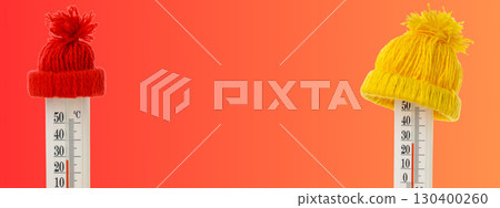 Vibrant knit hats rest atop thermometers indicating cold weather 130400260