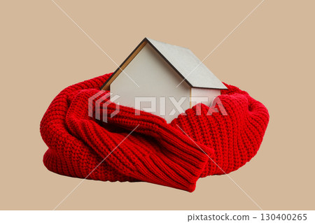Mini house wrapped in a cozy red scarf for warmth Mini house wrapped in a cozy red scarf for warmth 130400265