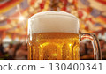 Close-up of refreshing cold foamy light beer in foggy glass stein in Oktoberfest tent with colorful blurred background. Festive food concept for Oktoberfest. 130400341