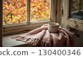 Cozy corner by an old frame with peeling paint of an Autumn Window. Corner with a Cup of coffee and Soft Blanket, Surrounded by Beautiful Fall Foliage. National Coffee Day concept. 130400346