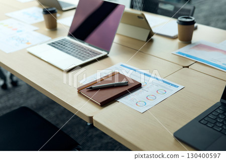 Laptop, notebook, and handouts placed in the conference room 130400597