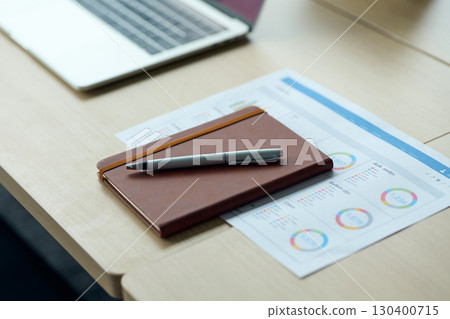 Laptop, notebook, and handouts placed in the conference room 130400715