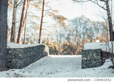 snow covered mountain road with stone walls in winter forest, scenic nature landscape with frosty trees and mountain view, concept of travel, adventure and eco tourism snow covered mountain road with stone walls in winter forest, scenic nature landscape with frosty trees and mountain view, concept of travel, adventure and eco tourism 130401052