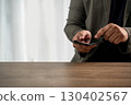 Business man checking phone with finger tap 130402567