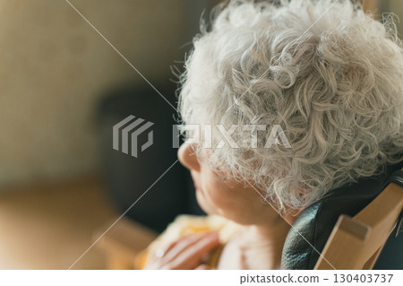 Elderly woman experiencing palpitations at home 130403737