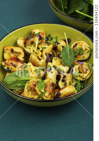 Cooked spinach dumplings in bowl. 130404122
