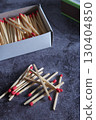Open wooden matchbox on a dark background 130404850