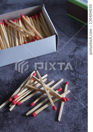 Open wooden matchbox on a dark background 130404850