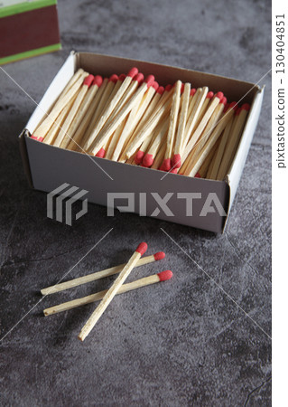 Open wooden matchbox on a dark background 130404851