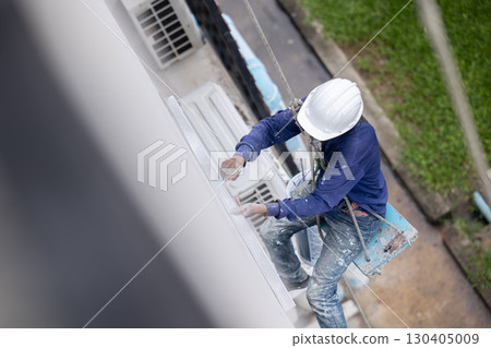 Exterior paint and leak repair technician builder, rope rappelling to repair buildings outside wall 130405009